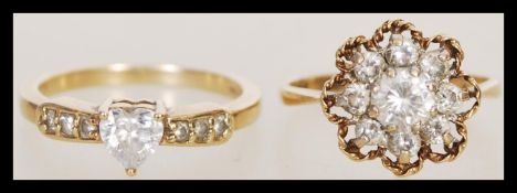 A hallmarked 9ct gold ring having a flower head set with white stones (m.5, hallmarked