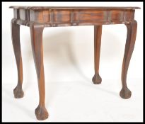 An early 20th Century South African Cape stinkwood writing table raised on ball and claw feet in the