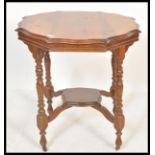 A 19th Century Victorian centre table having a round top with shaped edges, raised on four turned