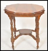 A 19th Century Victorian centre table having a round top with shaped edges, raised on four turned