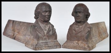 A pair of 19th Century Georgian cast iron fire dogs having busts to the ends modelled as the bust of