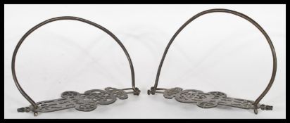 A pair of 19th Century Chinese bronze horse stirrups having decoration of fish and money medallions.