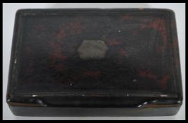 A late 18th / early 19th Century Georgian lacquered snuff pot of rectangular form, the hinged