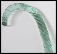 A 19th Century Nailsea glass walking stick of shaped tapering form having a twisted design.