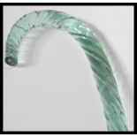 A 19th Century Nailsea glass walking stick of shaped tapering form having a twisted design.