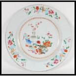 An 18th Century Chinese porcelain charger plate having hand painted central cartouche panel