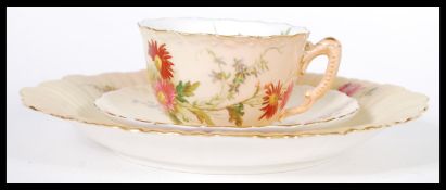 A Royal Worcester Ivory blush matched trio having chintz foliate pattern. The cup with puce mark