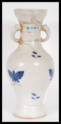 A 20th Century Chinese large vase having blue and white decoration of butterflies with twin elephant