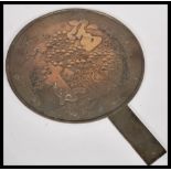 A 19th Century Japanese bronze hand mirror having decoration depicting character marks, birds and