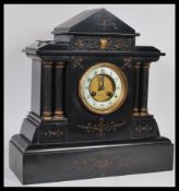 A Victorian 19th century 4 column slate mantel clock having inset 8 day movement  striking on a
