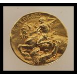 An 18ct gold French medallion of St Georges marked Becker having St George slaying the dragon and