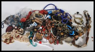 A selection of vintage costume jewellery to include beaded necklaces including faux pearls, bangles,