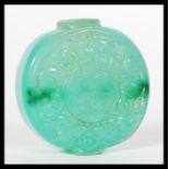 A 19th Century Chinese Jade bi disc snuff or perfume bottle of circular form with character marks