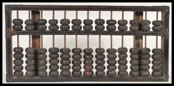 A 19th century Chinese abacus of typical beaded form, the top with applied brass supports to the