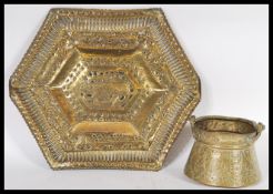 Two examples of early 20th Century Middle Eastern Persian Islamic brass to include a charger tray