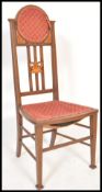 An Edwardian mahogany inlaid investiture chair being raised on tapered legs with stretchers having