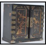 A 19th Century Japanese black lacquer cabinet having gilt decoration depicting birds having ornate