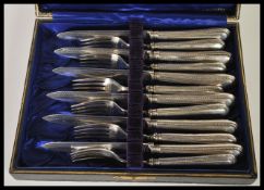 An early 20th Century Edwardian set of six and six hallmarked silver handled dessert forks and