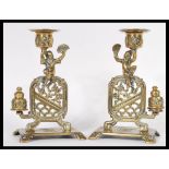 A fantastic pair of 19th Century Chinese figural bronze candlesticks raised on square bases with