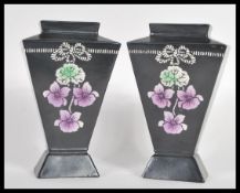 A pair of Shelley early 20th Century Art Nouveau vases having hand painted violet flowers and ribbon