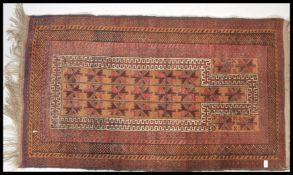 An early to mid 20th Century woven prayer mat / floor rug on brown ground, central panel,