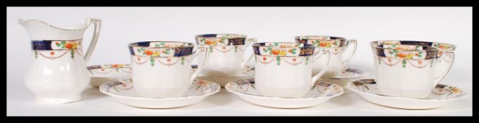 A 20th century tea set / service by Alfred Meakin, consisting of five cups, six saucers, creamer and