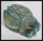 An unusual Chinese soapstone green jade type bid double sided toggle pendant in the form of a