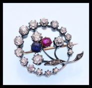A 19th Century Victorian ruby, diamond and sapphire brooch prong set with three old cut diamonds,