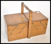 A 20th Century retro concertina sewing work box with metamorphic scissor action, inlaid detailing to