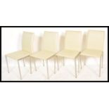 A set of 4 20th century modernist chrome and white faux leather dining chairs. Tubular chrome frames