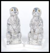 A pair of continental silver 800 stamped novelty condiments in the form of rabbits or hares raised
