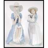 Two Nao porcelain ceramic figures of girls to include a girl seated in a bonnet together with a girl