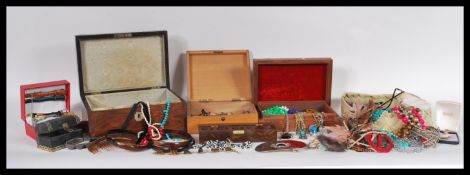 A collection of vintage costume jewellery set within a selection of jewellery boxes to include