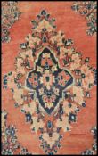 A 20th Century wool Persian floor carpet rug having a red ground central panel and geometric