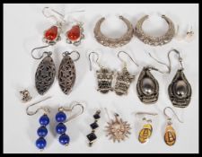 A selection of silver earrings to include a pair of embossed ethnic style earrings, earrings set
