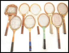 A group of vintage early to mid 20th Century sporting tennis rackets set in wooden frames.