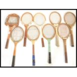 A group of vintage early to mid 20th Century sporting tennis rackets set in wooden frames.
