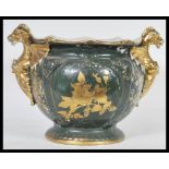 An unusual early 20th Century staffordshire ceramic planter / pot, twin handled in the form of two