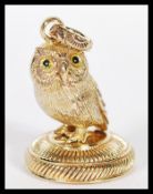 A gilt brass armorial wax seal fob pendant in the form of an owl.
