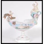 A continental ceramic figurine figural centerpiece bowl in the manner of Meissen / Dresden raised on