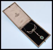 An early 20th Century Edwardian diamond and emerald necklace having a drop pendant design, the