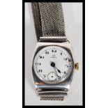 An early 20th Century Omega hallmarked silver watch having a white enamel face with bold numeral