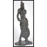 A 20th Century bronze sculpture statue depicting a musician playing a cello in suit raised on plinth