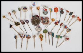 A collection of over 30 vintage 20th Century enamel badges and pins to include various Russian