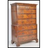 An 18th century George II walnut chest on chest of drawers / tallboy. The top comprising a flared