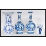 A collection of Delft blue and white ceramics dating from the 19th Century to include two vases