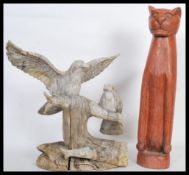 A 20th Century carved figural group depicting two birds perching on branches carved from a single