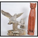 A 20th Century carved figural group depicting two birds perching on branches carved from a single