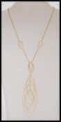 A 9ct gold ladies dress necklace with a curb chain and cascading ellipse drop detailing. Stamped