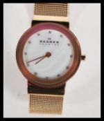 A ladies decorative yellow stainless steel Skagen - Denmark dress watch. Having a mother of pearl